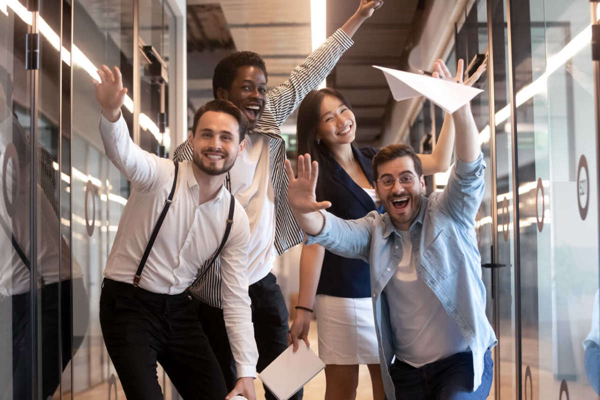 Overjoyed,funny,multiracial,millennial,employees,look,at,camera,having,fun