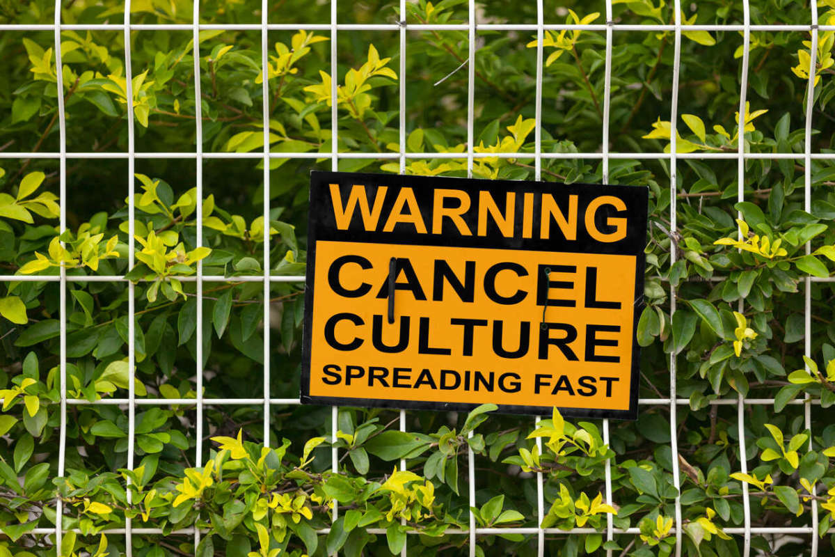 Black,and,yellow,warning,sign,on,a,fence,stating,"warning,