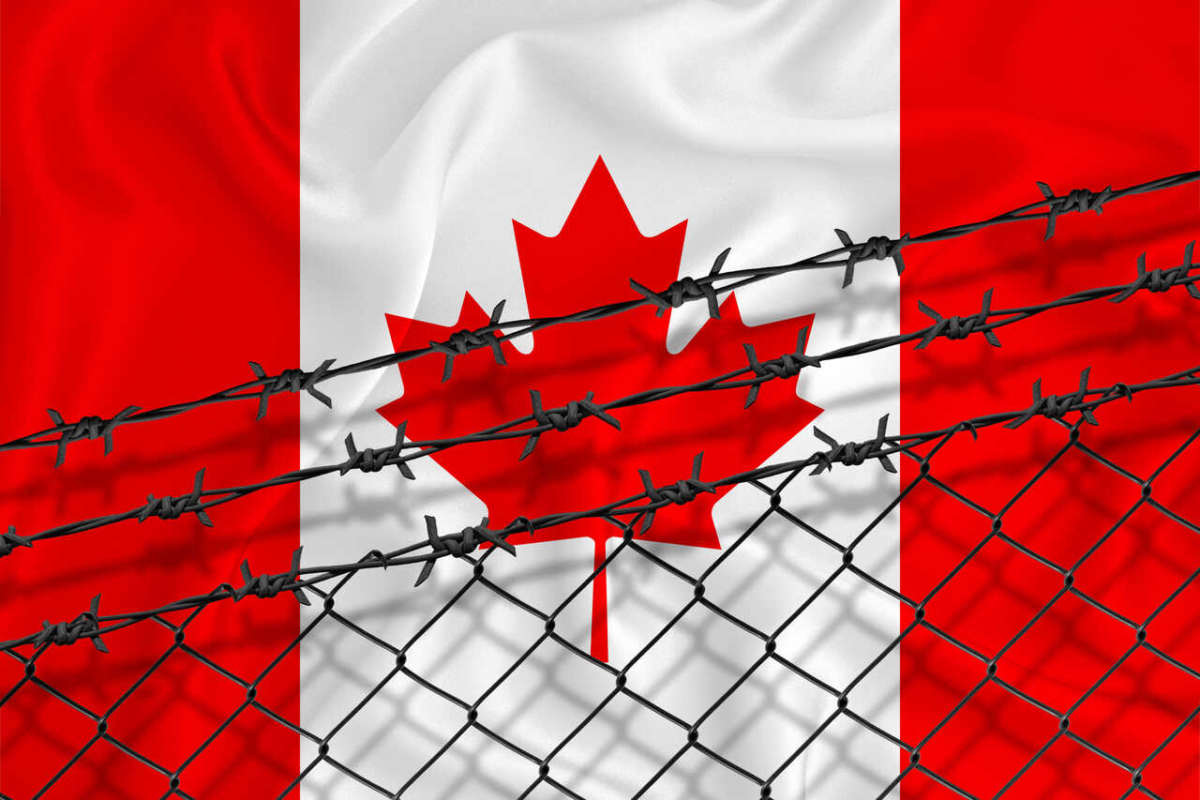 Developing,canada,flag,,mesh,fence,and,barbed,wire.,concept,of
